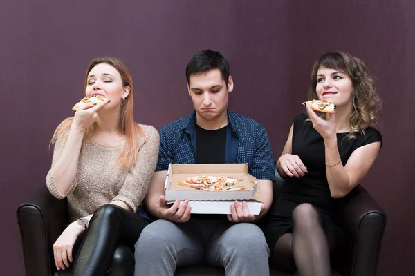 A man because of illness can not eat pizza jealous girls. Man dieting looks like girlfriends eat pizza.