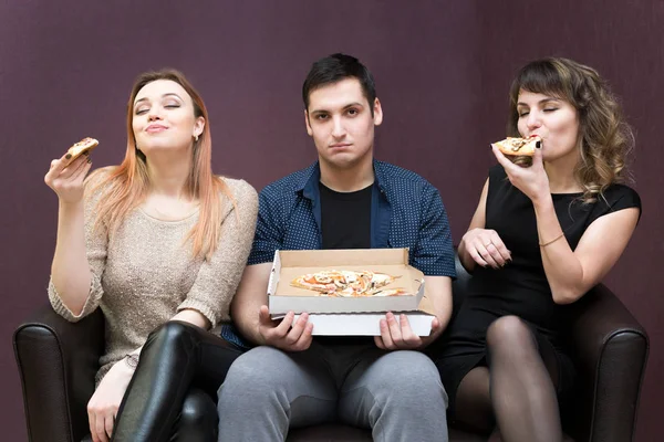 A man because of illness can not eat pizza jealous girls. Man dieting looks like girlfriends eat pizza.