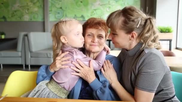 Adult Daughter Little Granddaughter Kiss Grandmother Women Same Family Hug — Stock Video