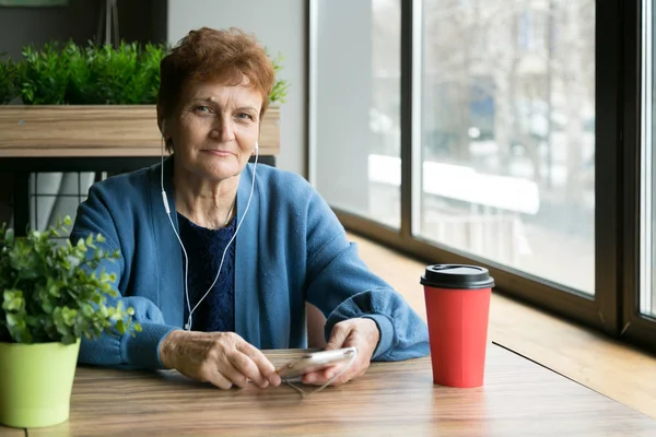 Una Pensionista Con Auriculares Escuchando Música Tomando Café Mirando Por —  Fotos de Stock