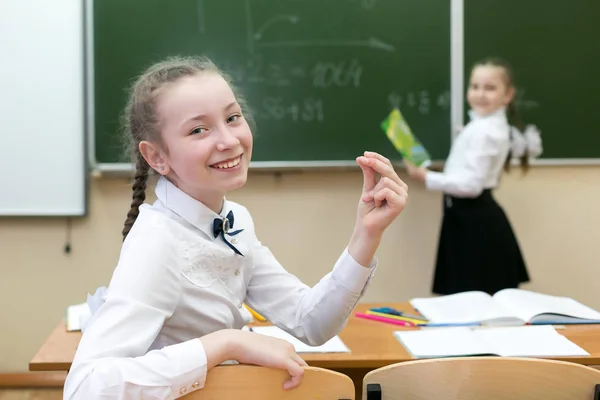 Schoolgirl had the idea of the right answer. Girl schoolgirl rejoices that he knows the correct answer to the question. Invented a brilliant idea.