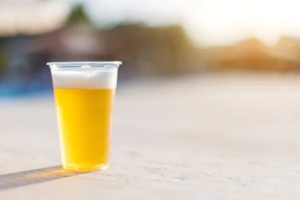 Plastic glass with cold beer. — Stock Photo, Image