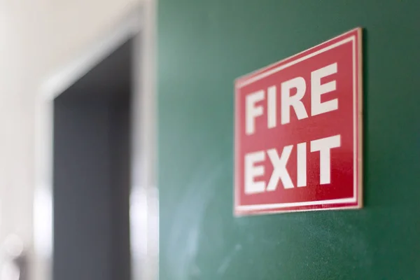 Emergency exit sign on hotel wall. — Stock Photo, Image