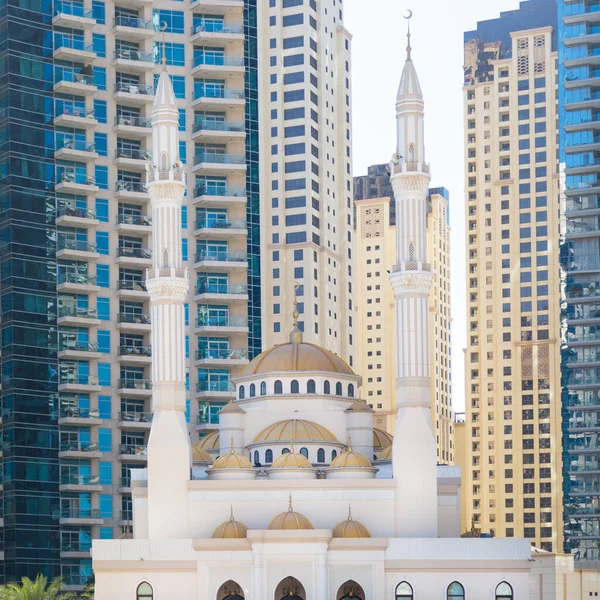 Muslim mosque among modern buildings. The White Mosque is surrounded by multi-storey office buildings.