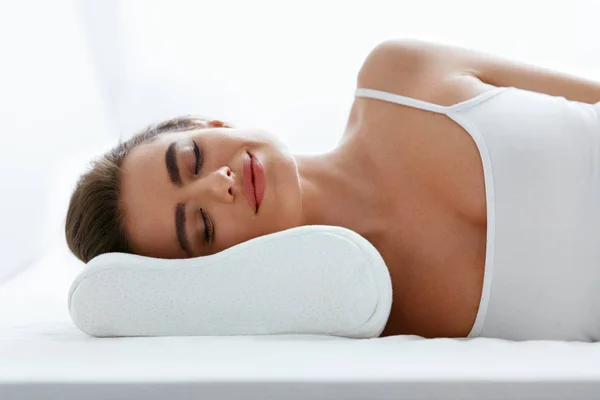 Woman Sleeping On White Orthopedic Pillow, Resting On Comfortable Mattress. High Resolution.