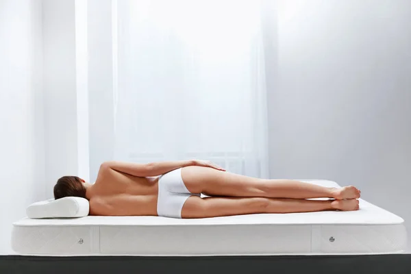 Orthopedic Mattress. Back View Of Woman Lying On Bed With  Pillow. High Resolution.