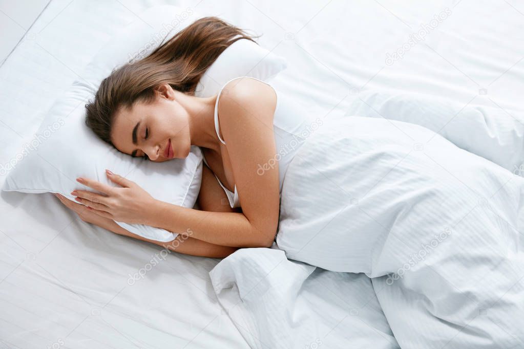 Healthy Sleep. Woman Sleeping On White Bedding, WIth Soft Pillow, Mattress With Blanket. High Resolution.