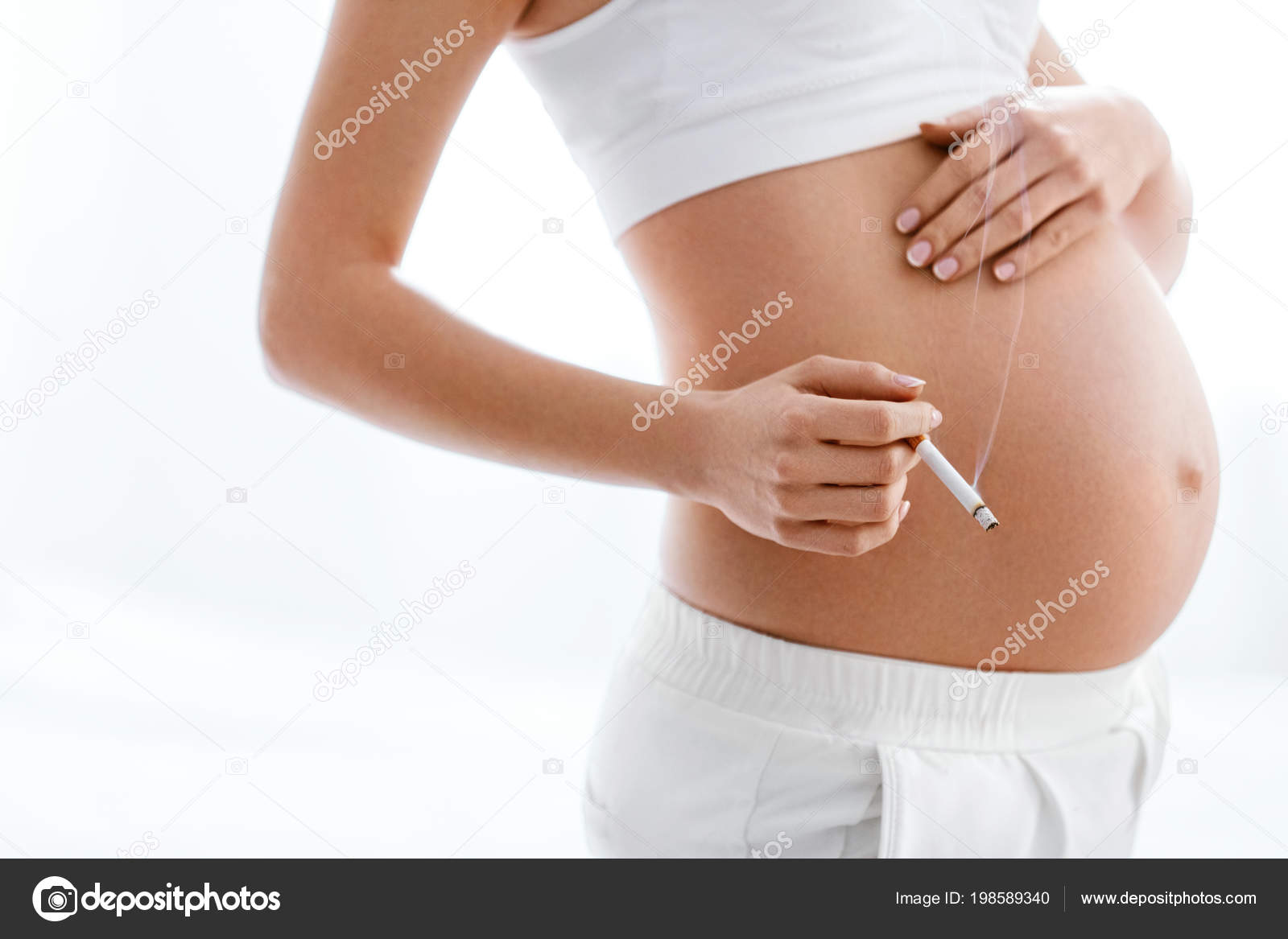 pregnant woman measuring her belly. Closeup female pregnant belly