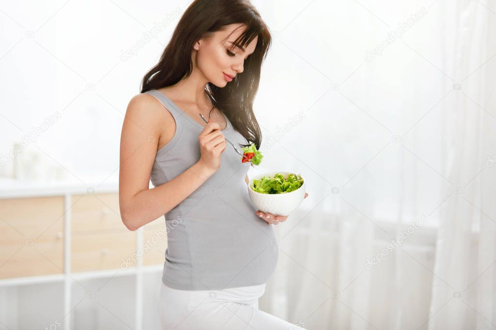 Pregnant Woman Eating Healthy Salad. Beautiful Female With Baby Belly On Diet Nutrition. High Resolution