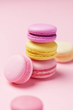 Macarons. Pembe bir arka plan üzerinde renkli Fransızca Macaroons. Tatlı veya çerezleri natürmort. Yüksek çözünürlük