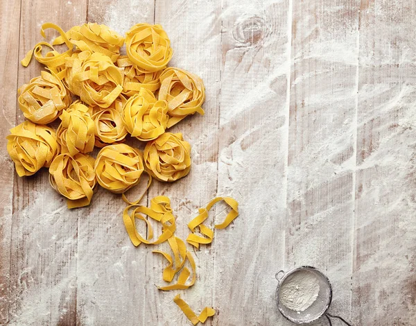 Making Pasta At Home. Closeup Of Hand Nested Pappardelle Pasta. High Resolution