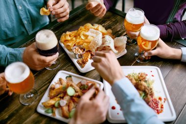 Bira içme ve aperatifler, lezzetli yemekler Closeup Pub restoranda yemek erkekler. Yüksek çözünürlük.