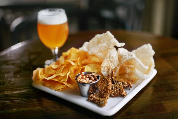 Beer With Snacks On Table In Pub Bar, Tasty Food On Wooden Table In Restaurant. High Resolution.