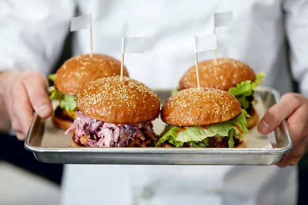 Food. Burgers And Hamburgers In Chef Hands Closeup. High Resolution