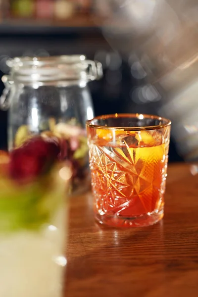 Cocktail Drink In Bar Close Up. Old Fashioned Cocktail With Orange Peel Garnish Bar Counter. High Resolution