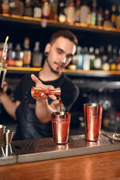 Cocktail. Bartender Making Cocktails in Bar. Barman Making Drinks Using Jigger And Shaker At Bar Counter. High Resolution