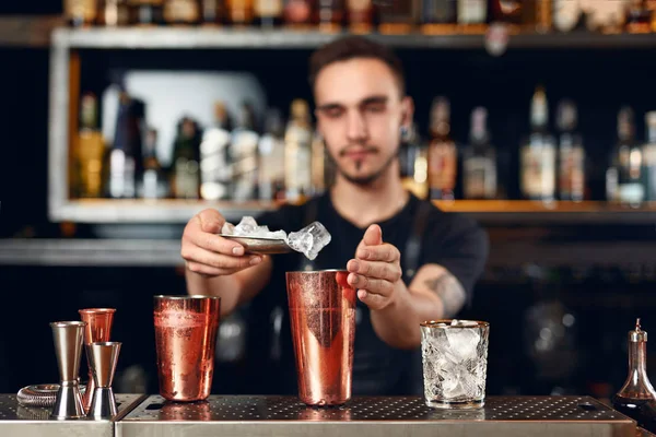 Bartender Making Cocktail. Barman Putting Ice In Glass, Preparing Cocktails At Bar Counter. High Resolution