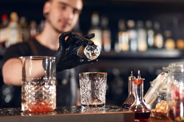 Bartender Making Cocktail. Barman Putting Ice In Glass, Preparing Cocktails At Bar Counter. High Resolution