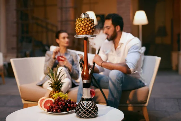 Fruit Shisha In Hookah Bar For Couple. People Smoking Hookah With Fruits, Resting In Luxury Lounge Cafe. High Resolution
