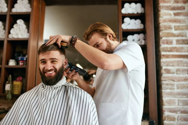 Barber Shop. Man Getting Haircut In Hair Salon. Hairdresser Cutting Hair With Trimmer, Doing Hairstyle. High Resolution