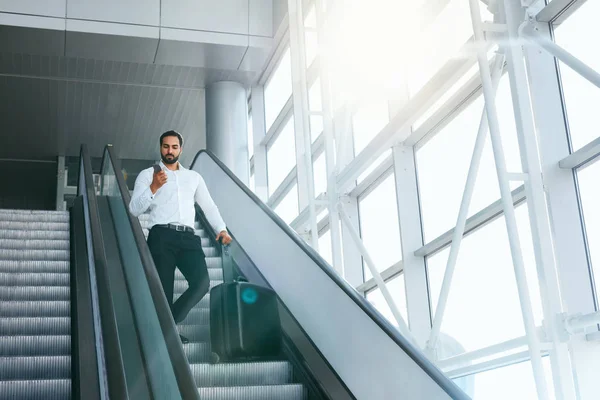 Business Trip. Business Man Traveling In Airport. Man With Suitcase Talking On Phone On Escalator. High Resolution