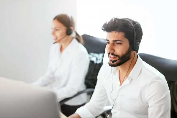 Contact Center Agent Consulting Customers Online. Man And Woman Working On Helpline In Call-Center. High Resolution