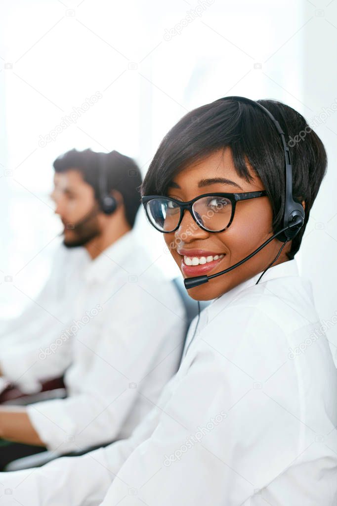 Call Center Agent Working On Hotline. Attractive Afro-American Woman Serving Customers In Contact Center. High Resolution