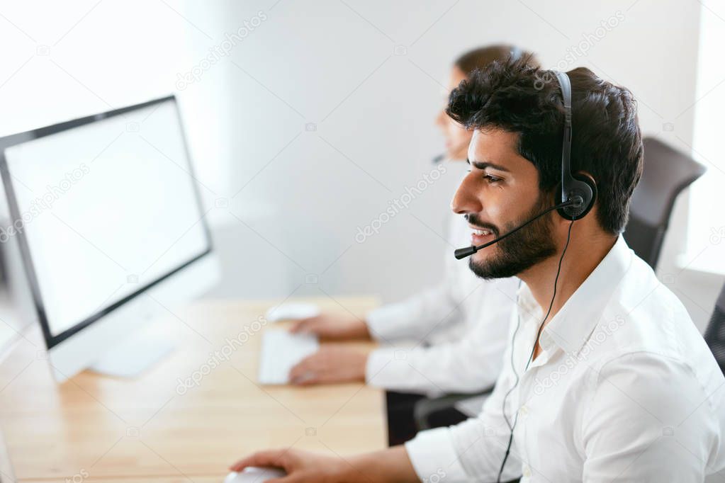 Contact Center Agent Consulting Customers Online. Man And Woman Working On Helpline In Call-Center. High Resolution