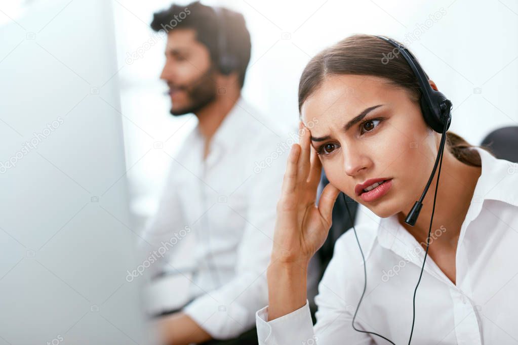 Tired Call Center Operator At Workplace. Woman With Headache Working On Helpline. High Resolution