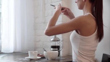 Gıda fotoğraf. Kahvaltı üstünde hareket eden telefon fotoğraf çekimi kadın