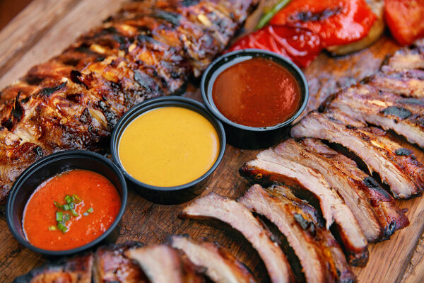 Food. Grilled Meat And Vegetables With Sauce Closeup. Grilles Pork Ribs In Restaurant. High Resolution