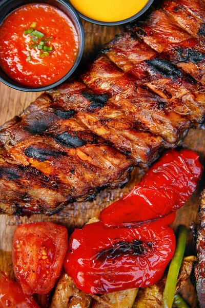 Food. Grilled Meat And Vegetables With Sauce Closeup. Grilles Pork Ribs In Restaurant. High Resolution