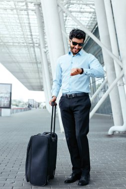 Business Trip. Man Traveling With Case At Airport clipart