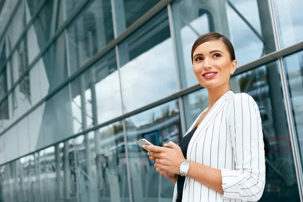 Obchodní žena pomocí telefonu poblíž kanceláře — Stock fotografie