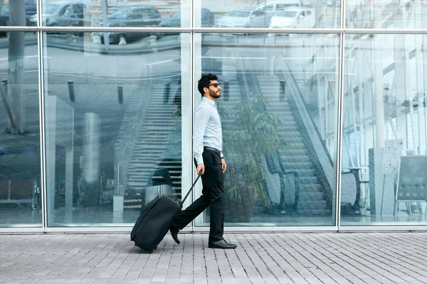 Business Trip. Man Traveling With Case At Airport