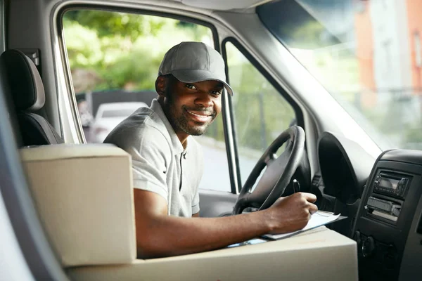Futár szállítás. Fekete férfi vezető szállítási autó vezetés — Stock Fotó