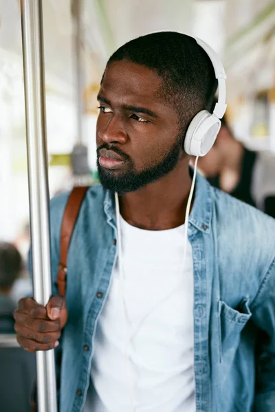 Listen Music. Black Man In Headphones Riding In Bus