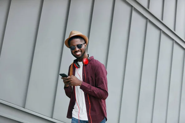 Erkek moda. Adam telefon ve kulaklık Caddesi üzerinde — Stok fotoğraf