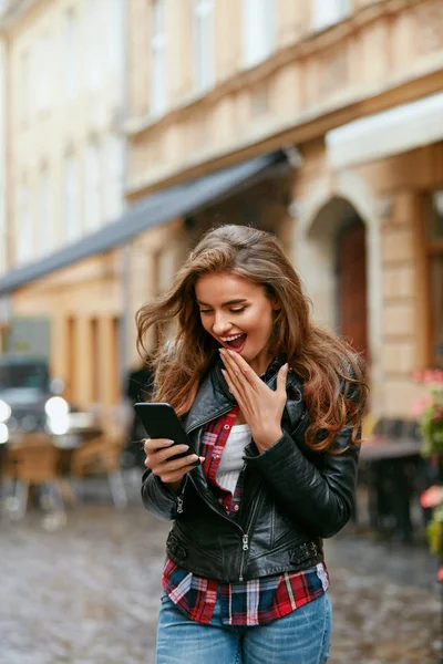 Woman Using Phone On Street