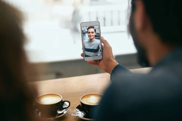 Video Calling On Phone. Hand With Phone And Face On Screen