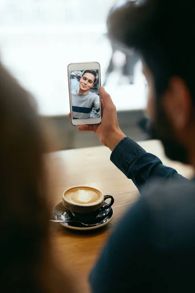 Video Calling On Phone. Hand With Phone And Face On Screen