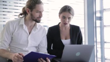 İş ofisi. Adam ve bilgisayarda çalışan kadın