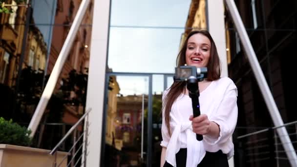 Video Blogging. Mujer con cámara cerca de moderno edificio de negocios — Vídeo de stock