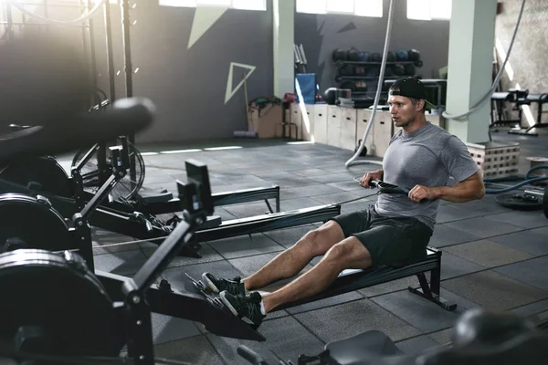 Functional Training. Man Doing Exercise On Rowing Machine At Gym — Stock Photo, Image