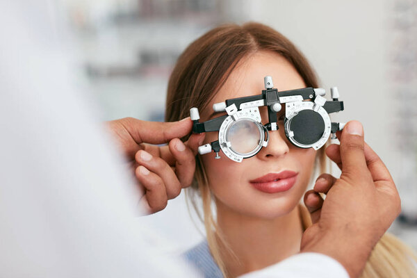 Eye Exam. Woman In Glasses Checking Eyesight At Clinic