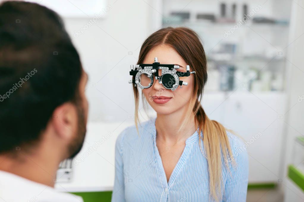 Optometry Test. Eye Doctor Checking Woman Eyesight At Clinic