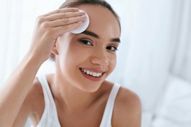 Clean Face. Beautiful Woman Cleaning Skin With Cosmetic Pad clipart