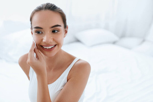 Clean Face. Beautiful Woman Cleaning Skin With Cosmetic Pad