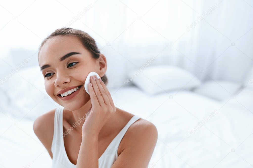 Clean Face. Beautiful Woman Cleaning Skin With Cosmetic Pad