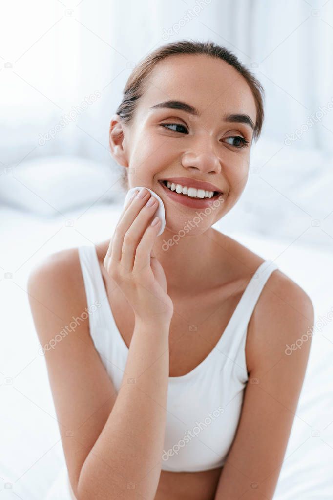 Clean Face. Beautiful Woman Cleaning Skin With Cosmetic Pad